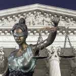Judge Banned for Life—Shocking Courtroom Drama Lady Justice statue in front of courthouse.