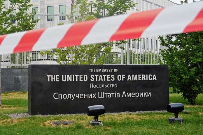 656626315 U.S. Embassy sign behind red-and-white caution tape.