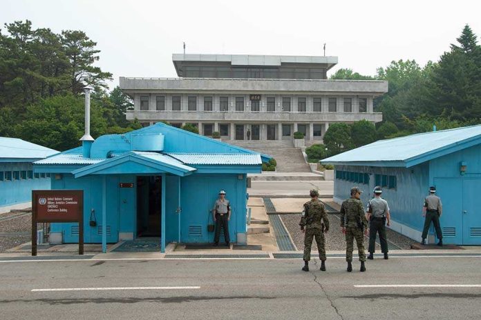 shutterstock_109012337 Military personnel standing near blue buildings at a border crossing