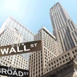 Dallas Mayor’s Bold Challenge to Wall Street Street signs for Wall Street and Broad Street with skyscrapers in the background
