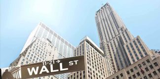 Dallas Mayor’s Bold Challenge to Wall Street Street signs for Wall Street and Broad Street with skyscrapers in the background