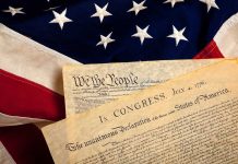 Trump’s Birthright Battle: Supreme Court Showdown The Declaration of Independence laid on an American flag