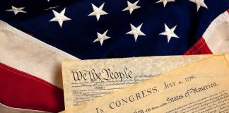Trump’s Birthright Battle: Supreme Court Showdown The Declaration of Independence laid on an American flag