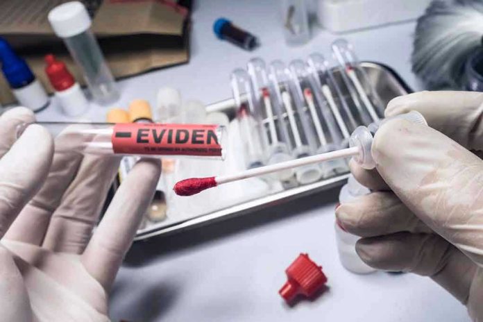 1701288700 Gloved hands holding evidence swab in laboratory.