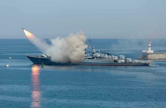 533229181-1 Warship firing missile in the sea.