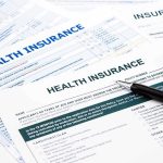 The Obamacare Enrollment Nobody Approved Close-up of health insurance application forms with a pen