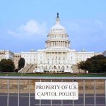 Congress Hide-And-Seek Over Jan. 6 View of the U.S. Capitol building with a security barrier in front