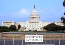 Congress Hide-And-Seek Over Jan. 6 View of the U.S. Capitol building with a security barrier in front