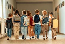 Government Forces Named In Child War Carnage A group of children walking together in a school hallway, each carrying a backpack