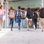Grooming Scandal Bombshell: Files Reopened Children running with backpacks outside a school building.