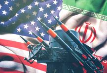 Iran Not Dead–But Definitely Bleeding Profusely Iran and USA flags with missile launcher.