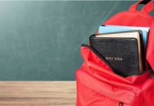 Schools Hide Gender Changes From Parents Red backpack with books on a classroom desk