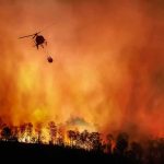Macron Orders War‑Room For Wildfires Helicopter fights massive wildfire over burning forest