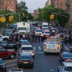Upper West Side Panic After Knife Rampage Police vehicles and officers block a city street during an active scene