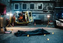Police HQ Firebombing Shocks America Police investigation at a crime scene with a covered body and evidence markers