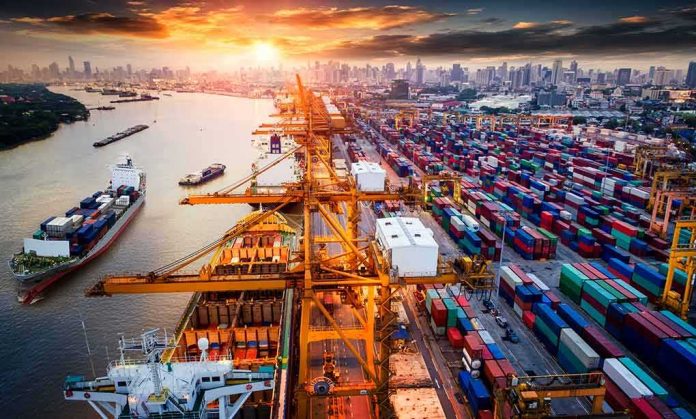 Container port with cranes and cargo ships at sunset