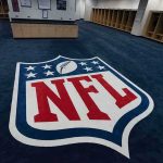 NFL End Zones Get Political—Again NFL logo on the floor of an empty locker room