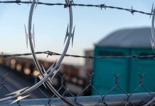EU Lawmakers Arrive at Border Then Get TURNED AWAY Razor wire on a chain-link fence
