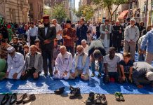 People praying together on a city street
