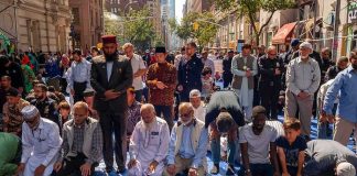 People praying together on a city street