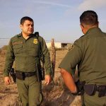 NC Citizen Files Damages Claiming Border Patrol Arrested Him, Then Left Him on the Roadside Two uniformed officers walking along a rural fence line