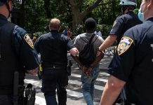 Armed Stalker Nabbed At Trump Golf Club Police escort a handcuffed man across a city street