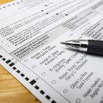 DOJ Clash Erupts Inside Wyoming Polls Ballot paper with pen on wooden surface