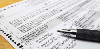DOJ Clash Erupts Inside Wyoming Polls Ballot paper with pen on wooden surface