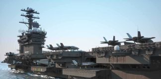 Aircraft carrier at sea with fighter jets on deck