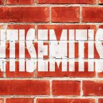 NYC Missed the Warning Signs Before Jewish Mother Was Killed Brick wall with large white stencil text