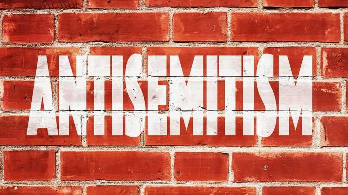 shutterstock_473788954 Brick wall with large white stencil text