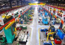 Aerial view of a large industrial workshop filled with various machinery and equipment