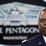 Lloyd Austin speaking at a podium in front of a Pentagon emblem