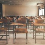 Cambridge’s DEI Poster Child Found Dead After Career Implodes Empty classroom with rows of wooden desks and chairs