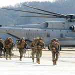 Missile Attacks on U.S. Troops Kept QUIET Soldiers disembark and walk past a large military helicopter