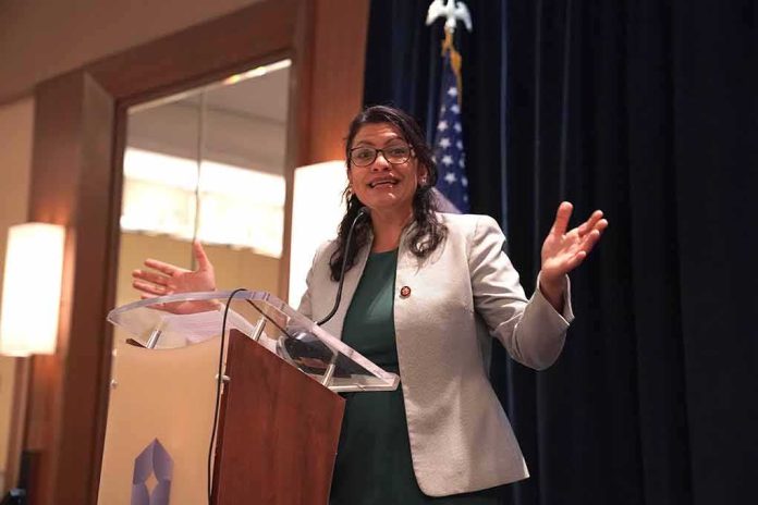 Woman speaking at a podium with hands raised