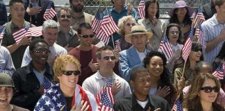 Robert Ugrina among a crowd holding American flags during a patriotic event