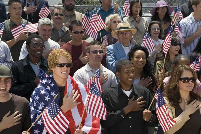 shutterstock_144639626 Robert Ugrina among a crowd holding American flags during a patriotic event