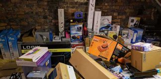 pile of assorted cardboard boxes and retail packages in a storage room