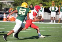 College Football Player Killed in Shocking Attack Football player in red runs with the ball as defender in green attempts a tackle