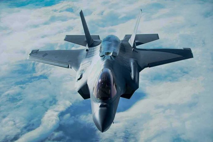 Stealth fighter jet flying above clouds