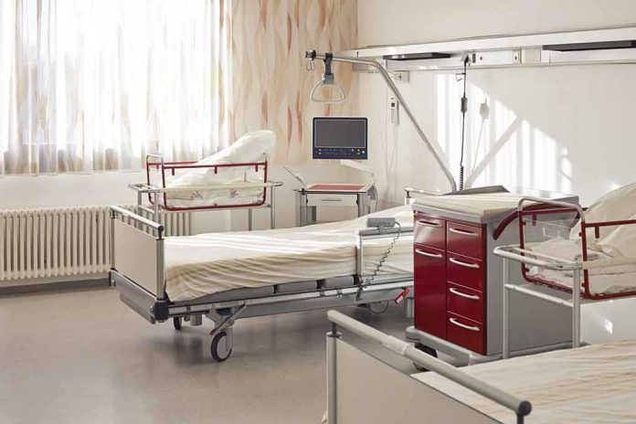 shutterstock_178580618 A hospital room featuring empty patient beds and medical equipment