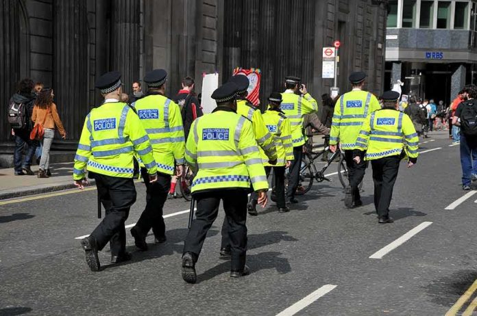 shutterstock_1850331643 Police officers in high-visibility jackets walking on a city street