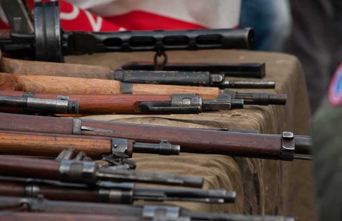 shutterstock_1914876166 Vintage rifles displayed on a table