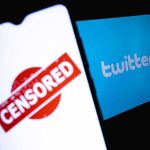 smartphone showing censored stamp beside twitter logo