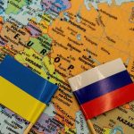 Ukraine and Russia flags on a map of Eastern Europe