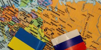 Ukraine and Russia flags on a map of Eastern Europe