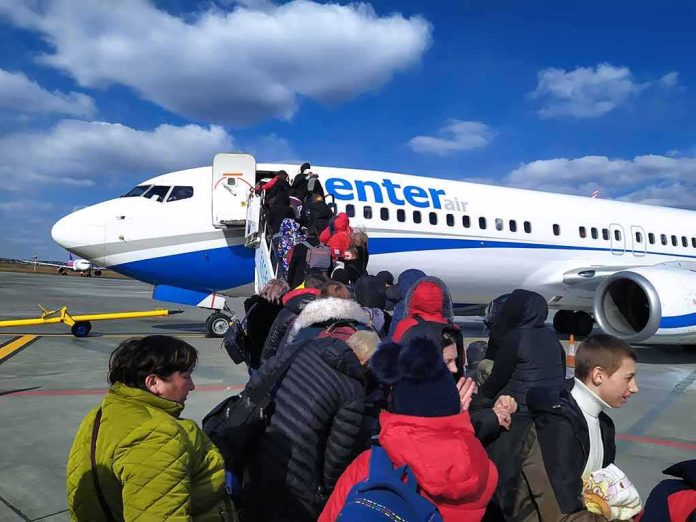 shutterstock_2138795841 Passengers boarding a commercial airplane via mobile stairs