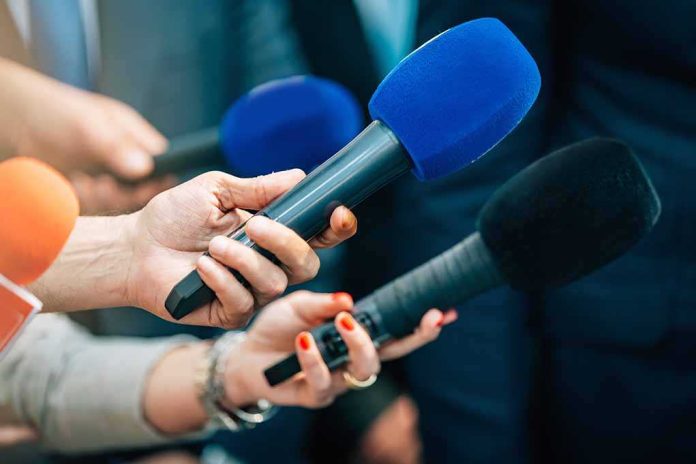 shutterstock_2168392339-7 Reporters holding colorful microphones