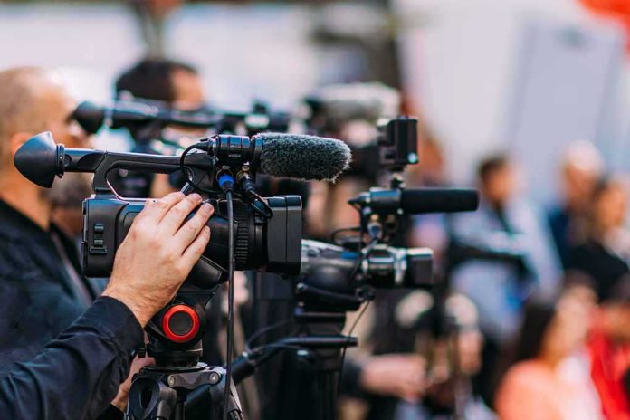 shutterstock_2233193507-6 Video cameras on tripods at a media event